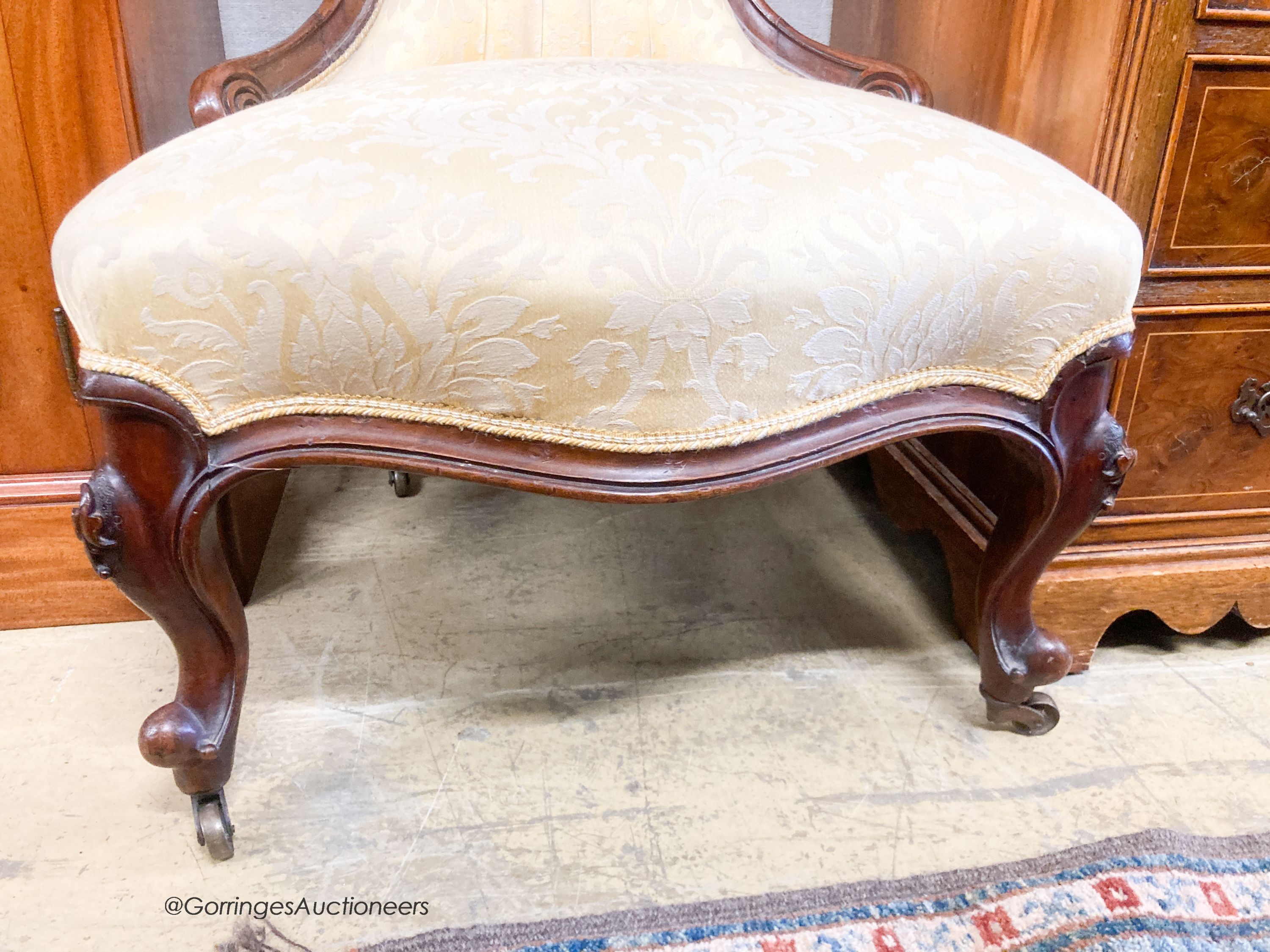 A Victorian walnut spoonback nursing chair